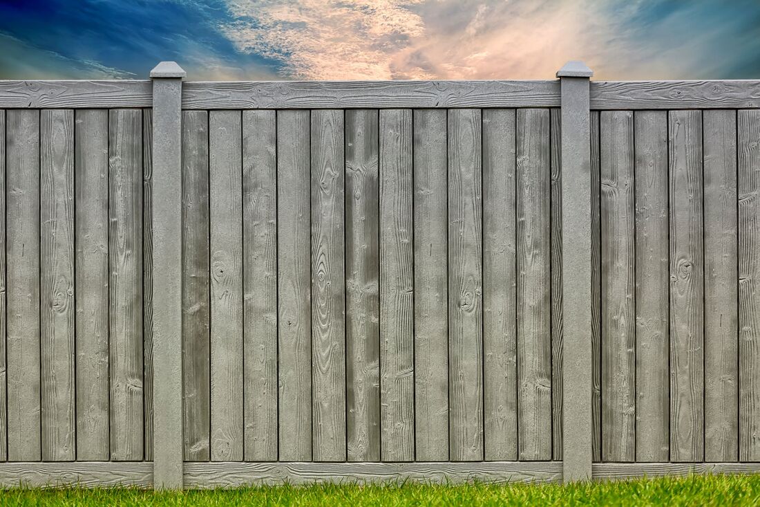 Gray composite privacy fence with gate