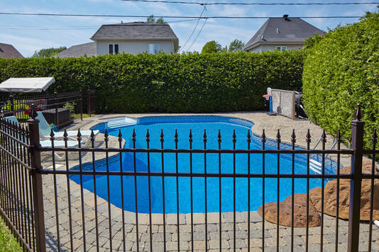 Black aluminum rail fence around pool